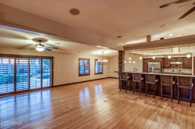 a view of a patio with table and chairs under an umbrella
