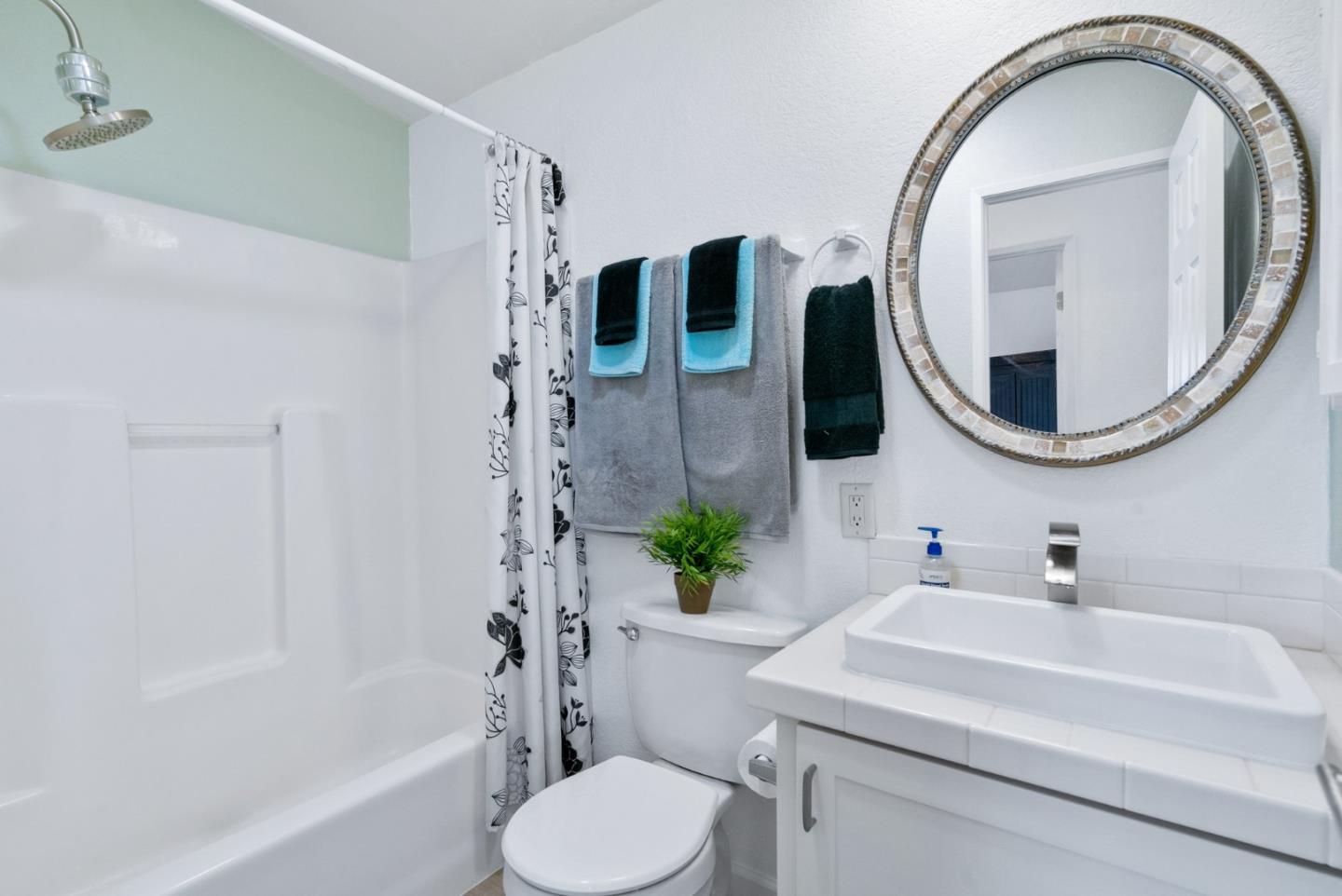100 North Rodeo Gulch Road, Unit 65 Soquel, CA 95073 - Photo 19 of 33 a bathroom with a sink a toilet and a mirror