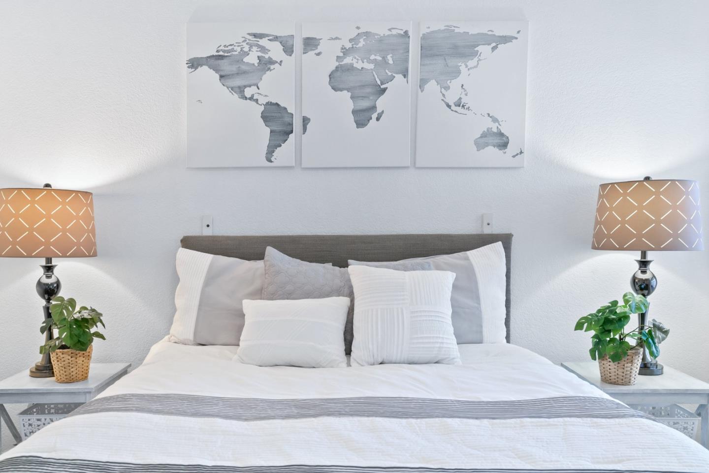 100 North Rodeo Gulch Road, Unit 65 Soquel, CA 95073 - Photo 23 of 33 a bedroom with a bed painting on wall and a potted plant