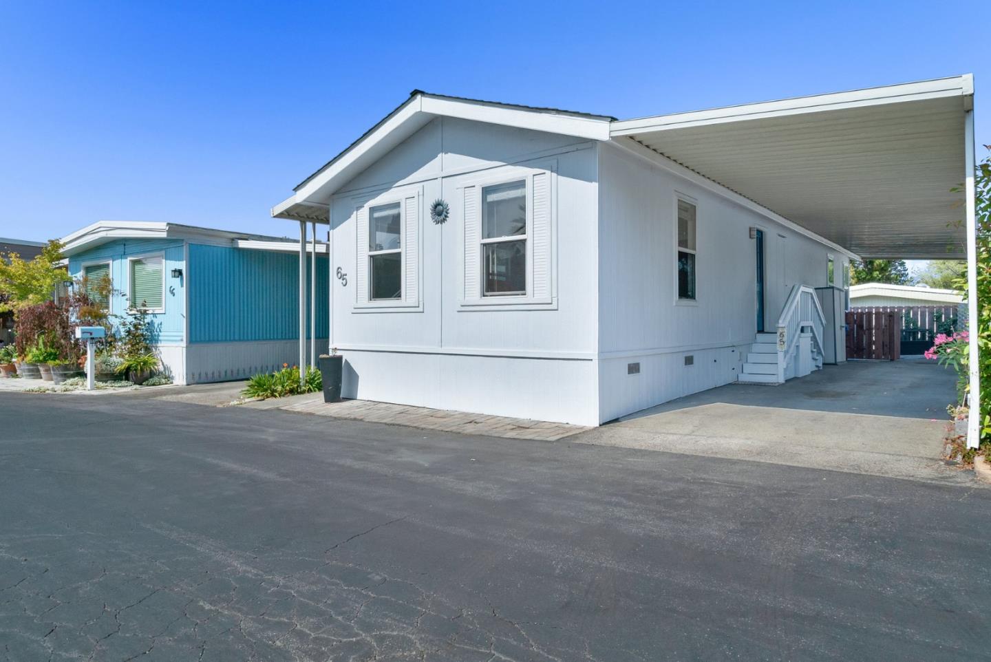 100 North Rodeo Gulch Road, Unit 65 Soquel, CA 95073 - Photo 30 of 33 a front view of a house with a yard and garage