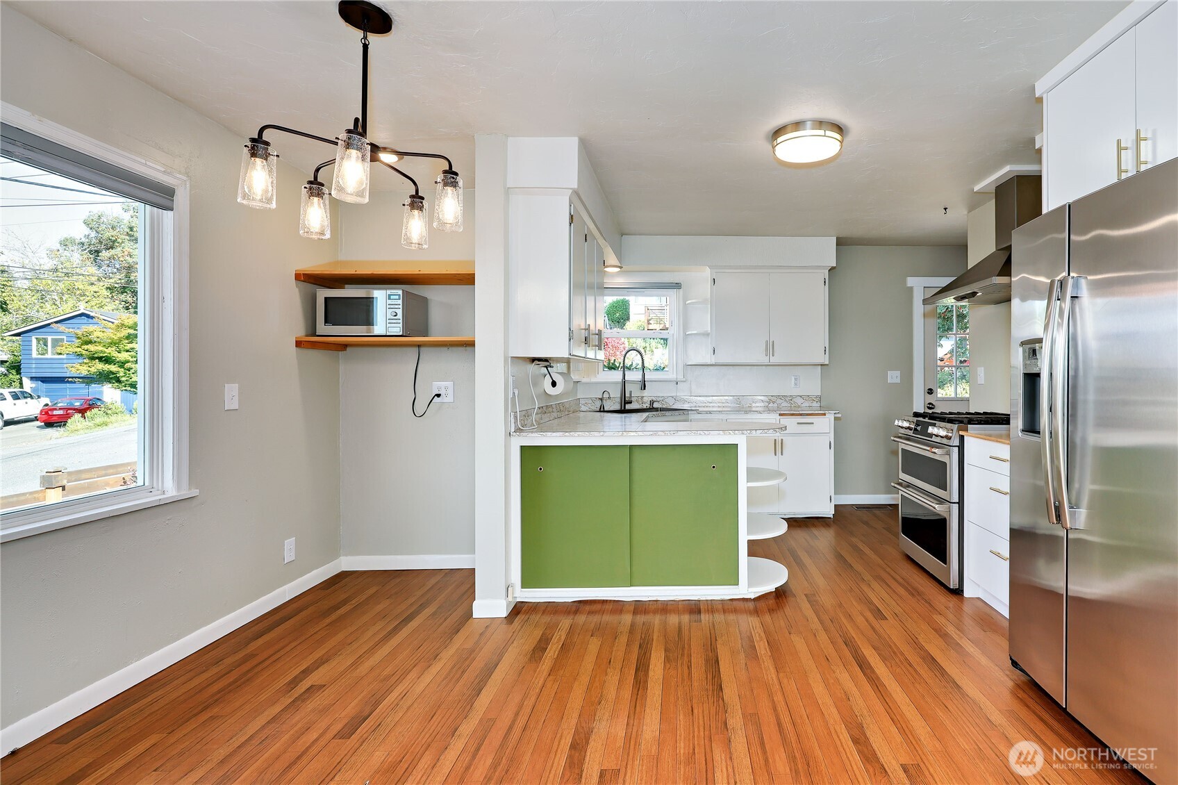 1518 Winfield Avenue Bremerton, WA 98310 - Photo 11 of 38 a kitchen with stainless steel appliances granite countertop a refrigerator a oven a stove and a wooden floor