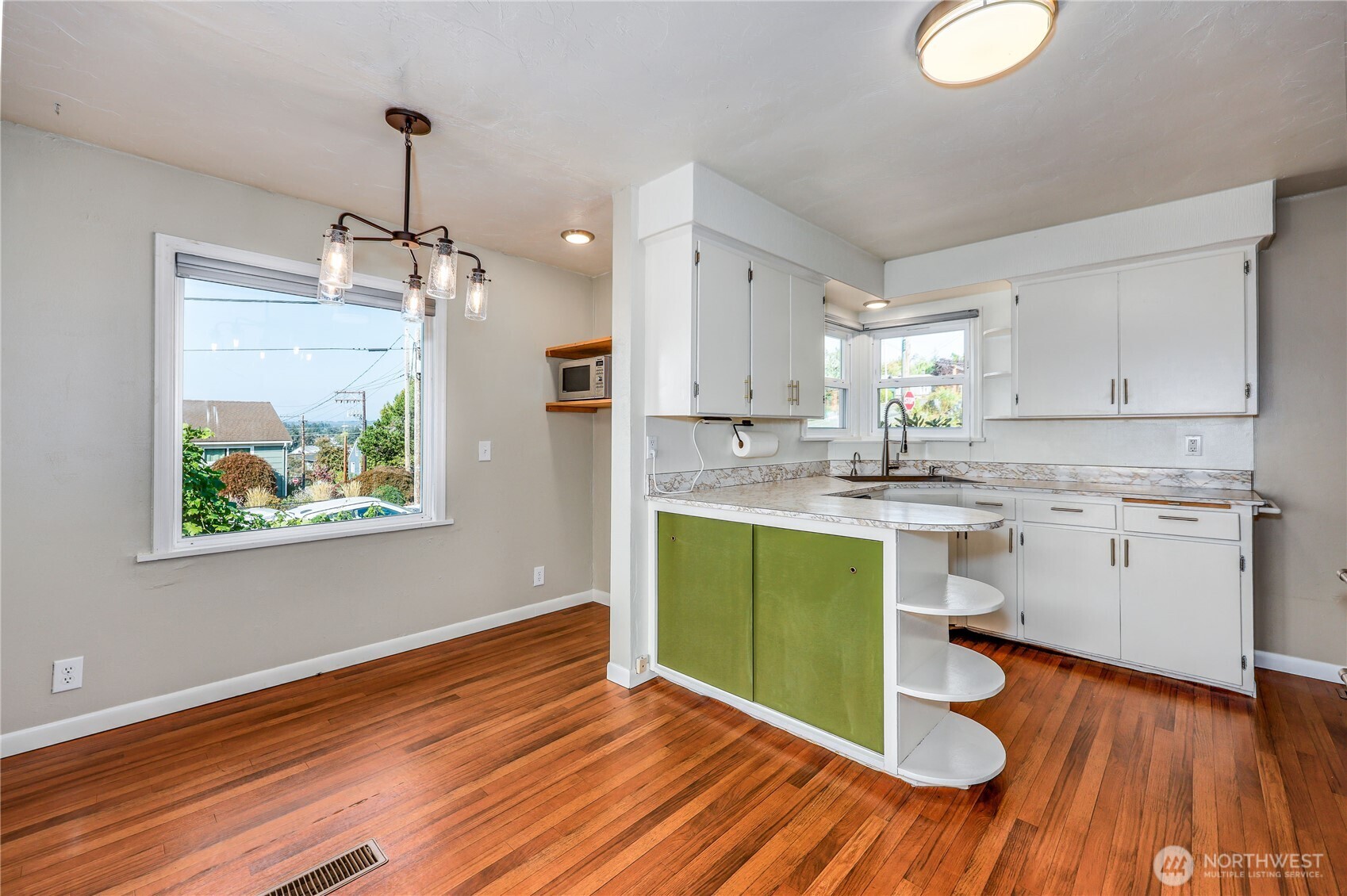 1518 Winfield Avenue Bremerton, WA 98310 - Photo 12 of 38 a kitchen with a sink cabinets stainless steel appliances and a wooden floor