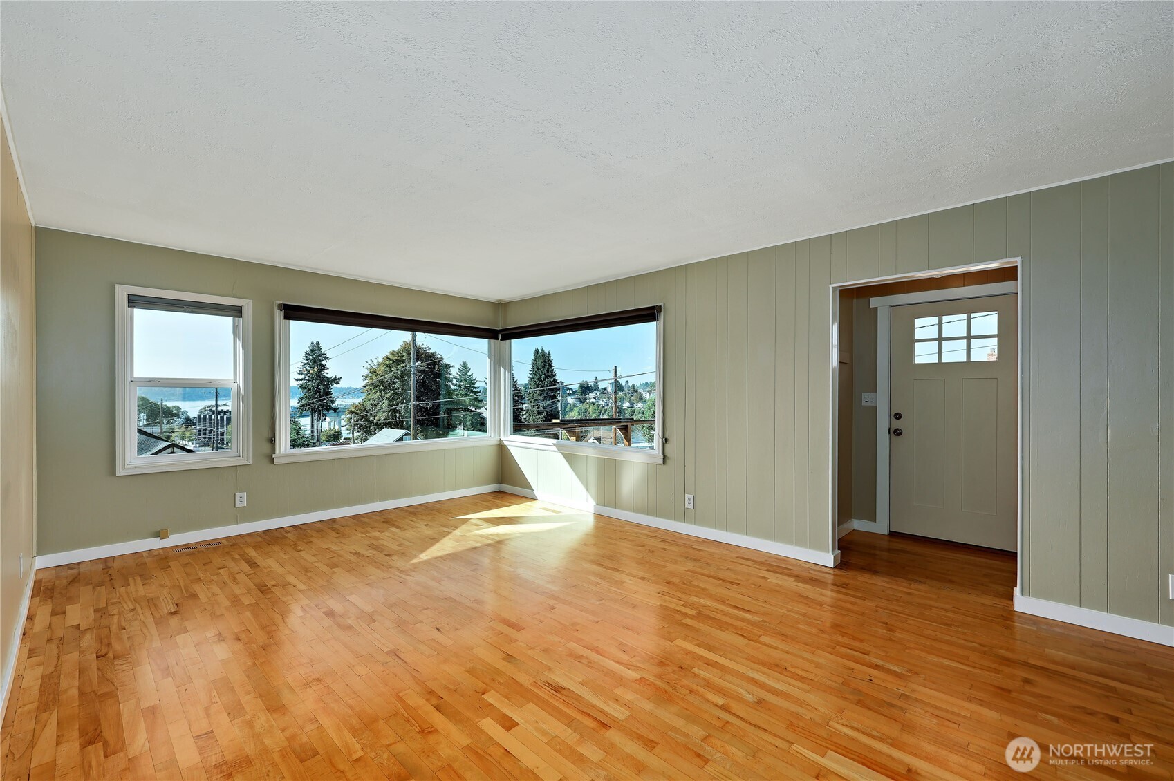 1518 Winfield Avenue Bremerton, WA 98310 - Photo 9 of 38 a view of an empty room with wooden floor and a window