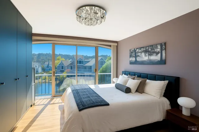 a bedroom with a large bed and a large window