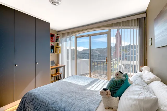 a bedroom with a bed and a large window