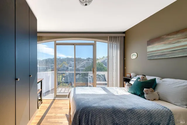 a bedroom with a large bed and a large window with outer view