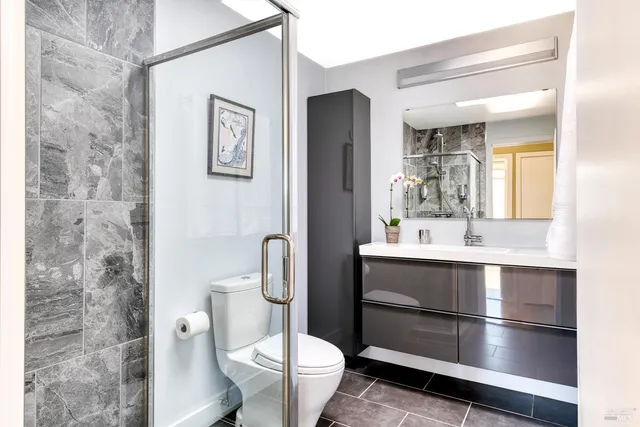 a bathroom with a sink toilet and shower