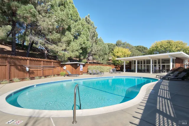 a view of a swimming pool with seating space