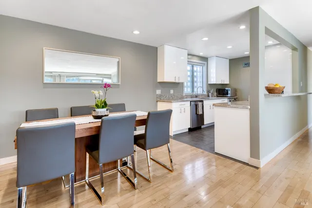 a view of kitchen with cabinets table and chairs