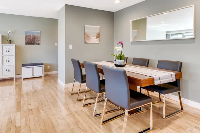 a view of a dining room with furniture and wooden floor