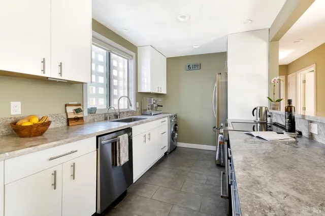 a kitchen with a sink stove and cabinets