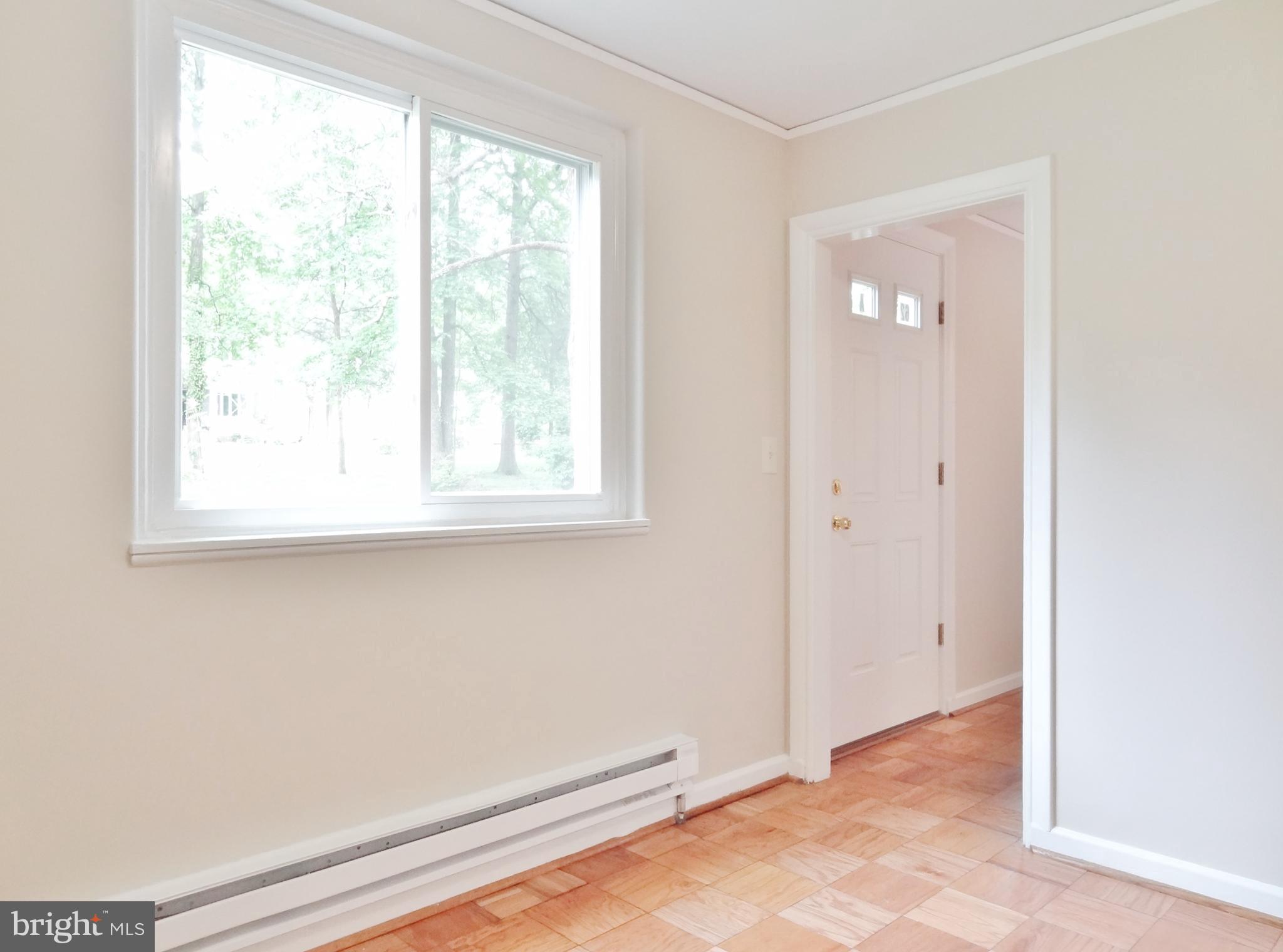 Brightly lit Dining Rm looking at Garden Side Door