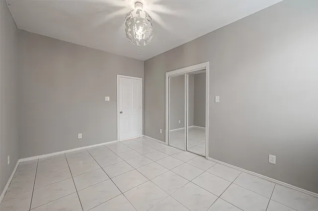 a view of an empty room with a chandelier