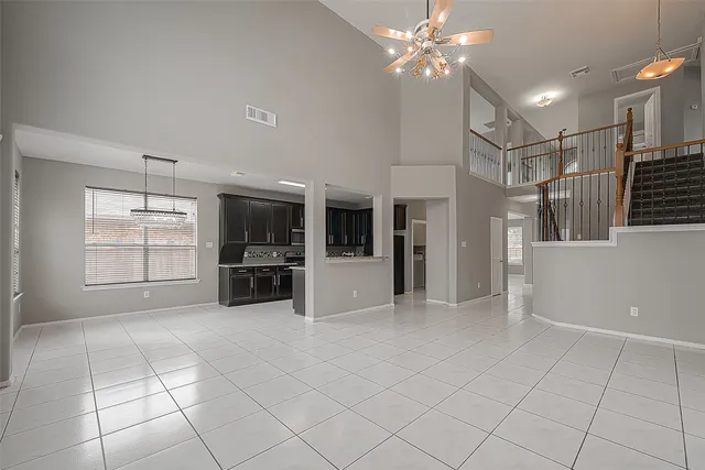 a view of a livingroom with a furniture ceiling fan and window