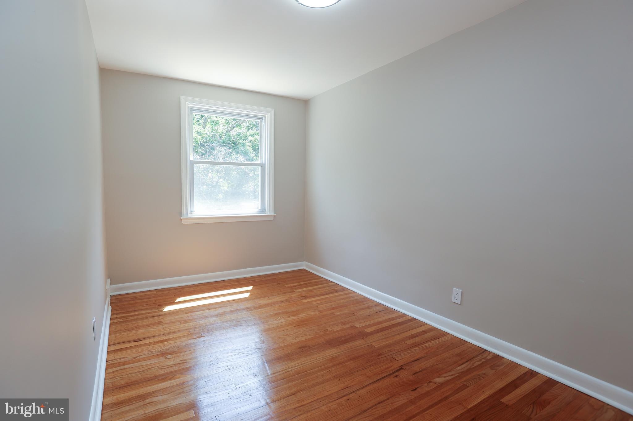 607 Briarcliff Road Upper Darby, PA 19082 - Photo 13 of 23 an empty room with wooden floor and windows