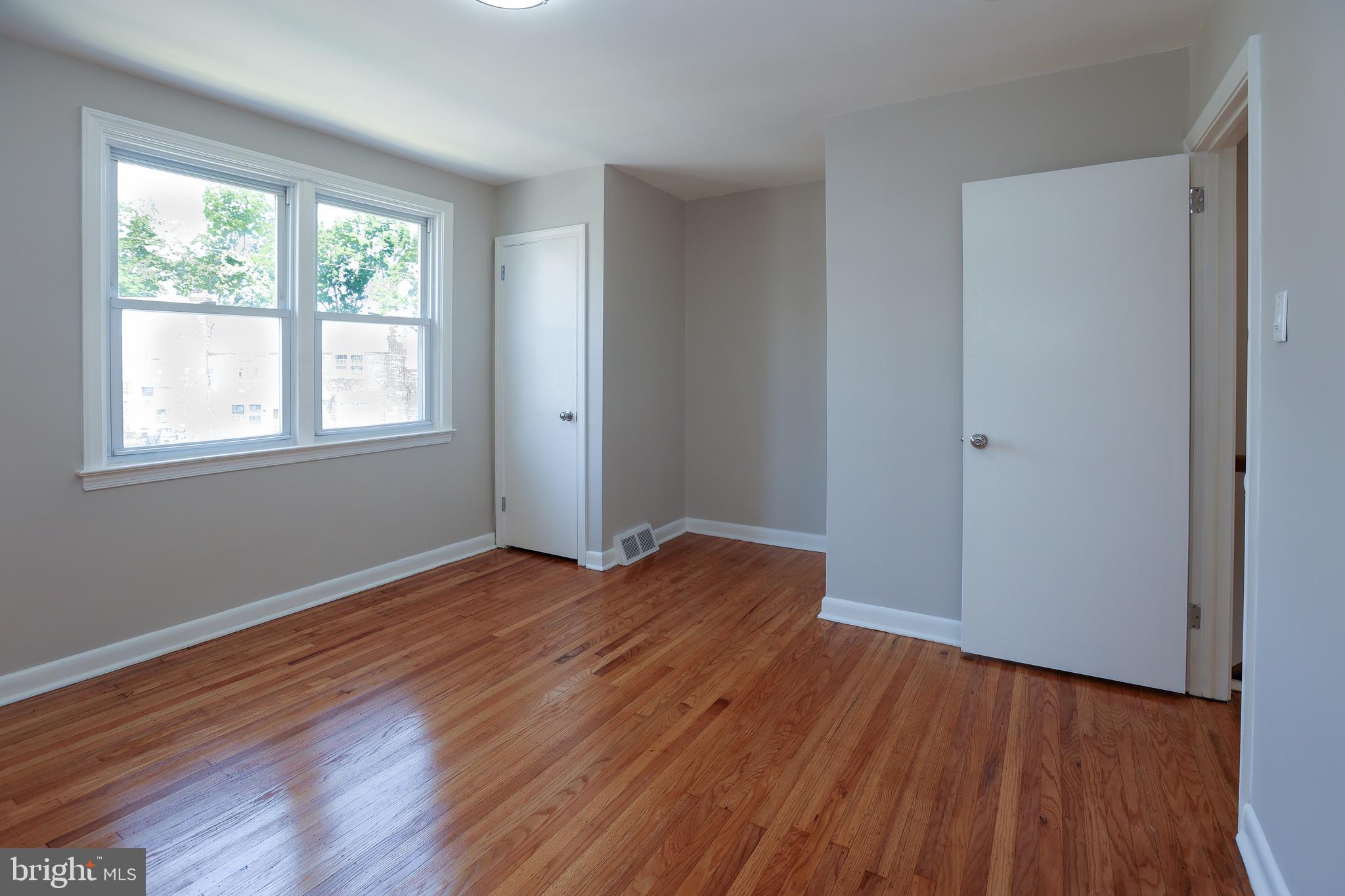 607 Briarcliff Road Upper Darby, PA 19082 - Photo 16 of 23 an empty room with wooden floor and windows