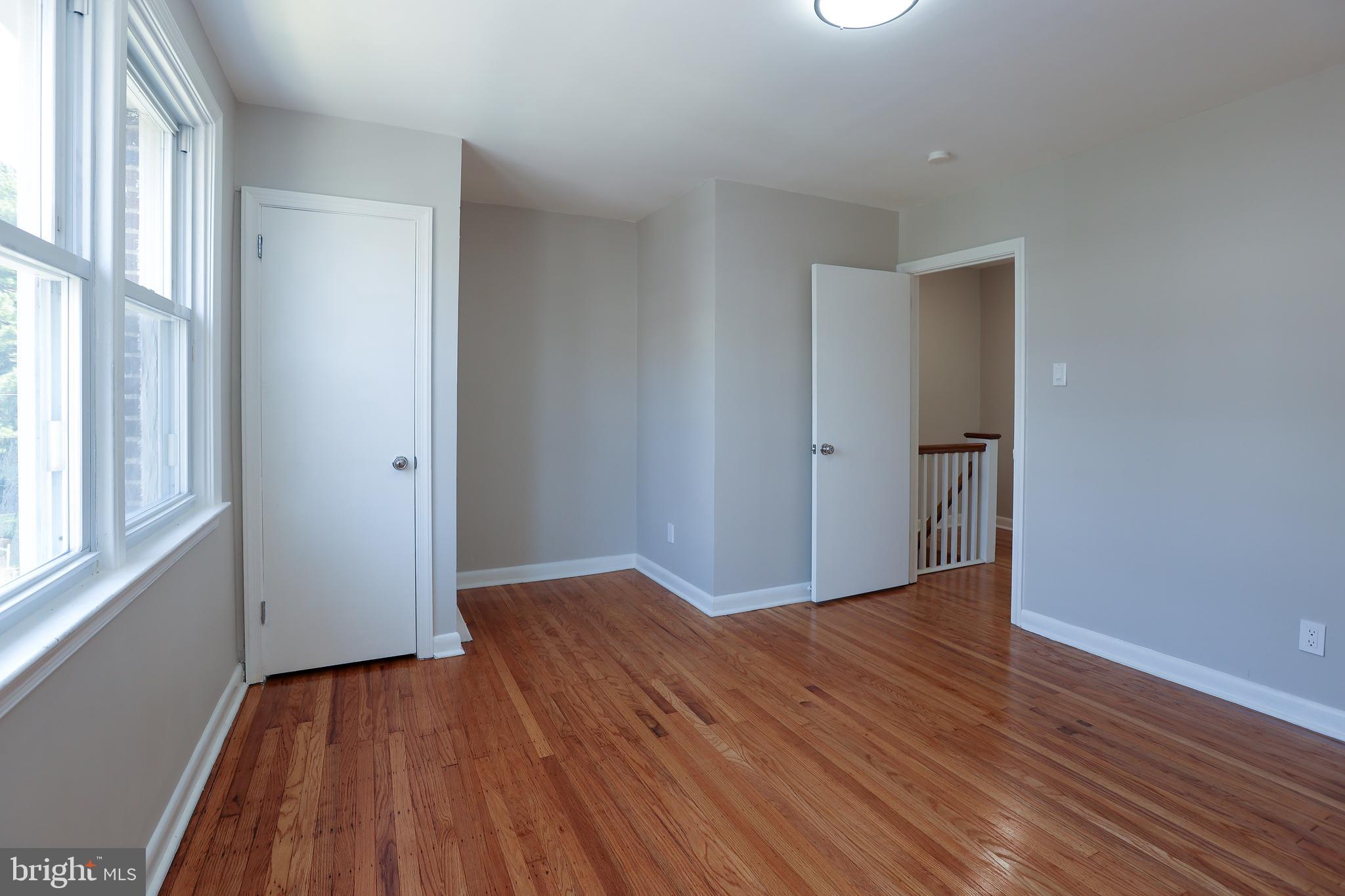 607 Briarcliff Road Upper Darby, PA 19082 - Photo 17 of 23 wooden floor in an empty room with a window