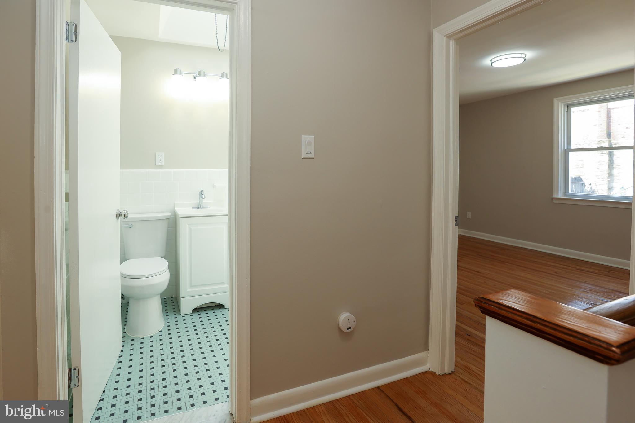 607 Briarcliff Road Upper Darby, PA 19082 - Photo 18 of 23 a bathroom with a toilet a sink and a window