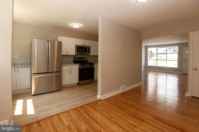 a kitchen with stainless steel appliances a refrigerator and a stove top oven