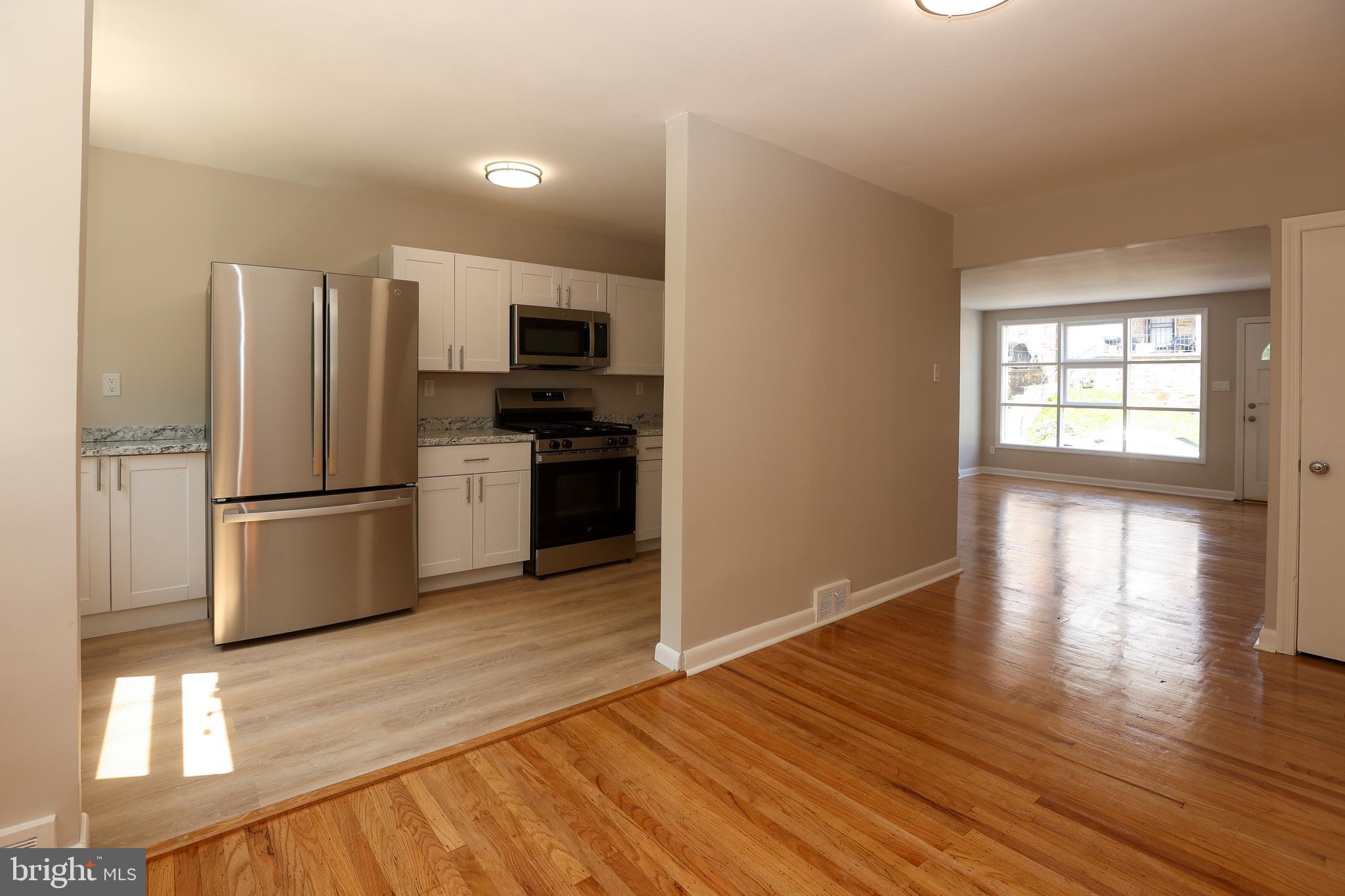 607 Briarcliff Road Upper Darby, PA 19082 - Photo 5 of 23 a kitchen with stainless steel appliances a refrigerator and a stove top oven