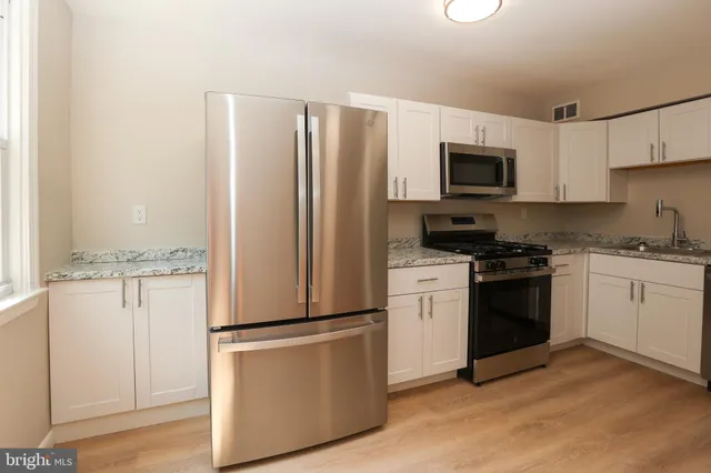 a kitchen with a refrigerator stove and sink