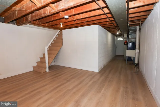 a view of a room with wooden floor and stairs