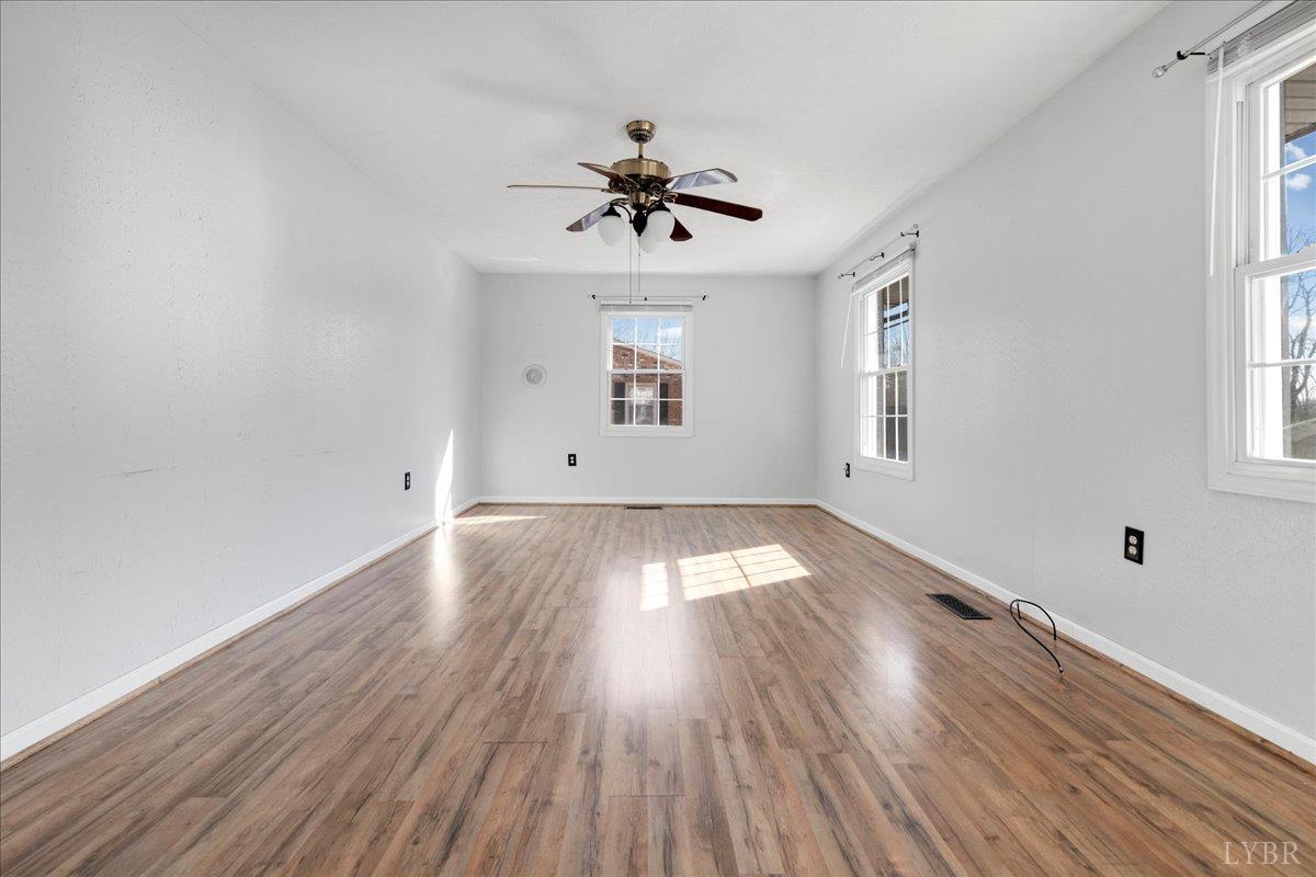 813 Doss Road Concord, VA 24538 - Photo 8 of 31 wooden floor in an empty room with a window