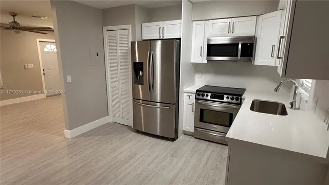 a kitchen with stainless steel appliances a refrigerator stove and microwave