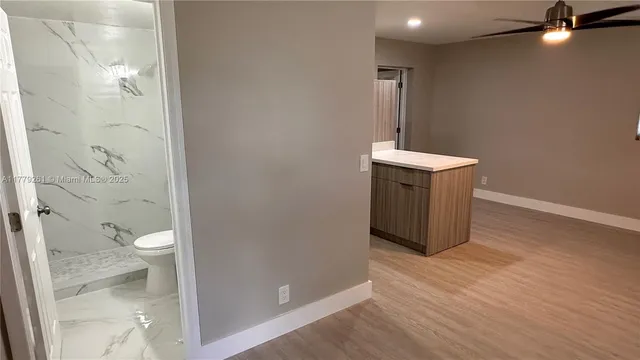 a bathroom with a sink a toilet a shower and a mirror