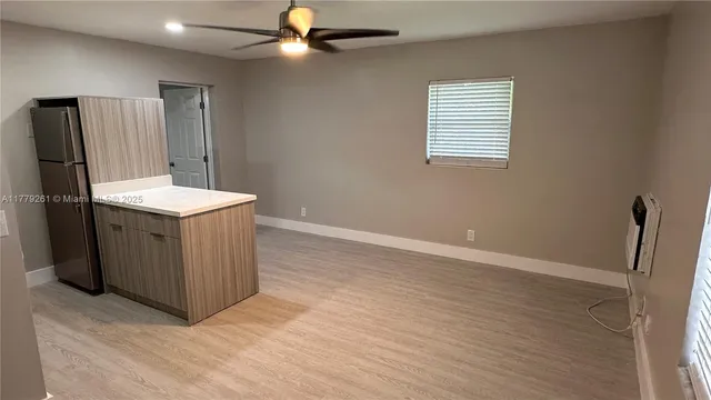 a view of a kitchen with a sink and wooden floor