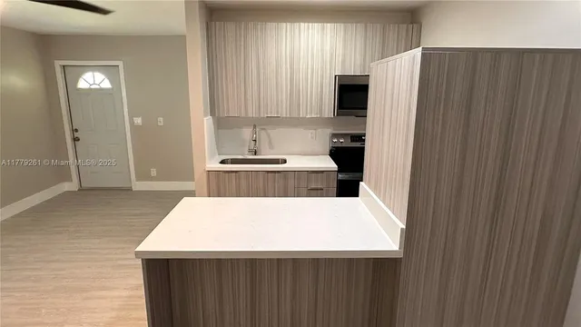 a kitchen with stainless steel appliances a refrigerator and a stove top oven