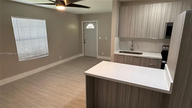 a kitchen with a stove a sink and a refrigerator