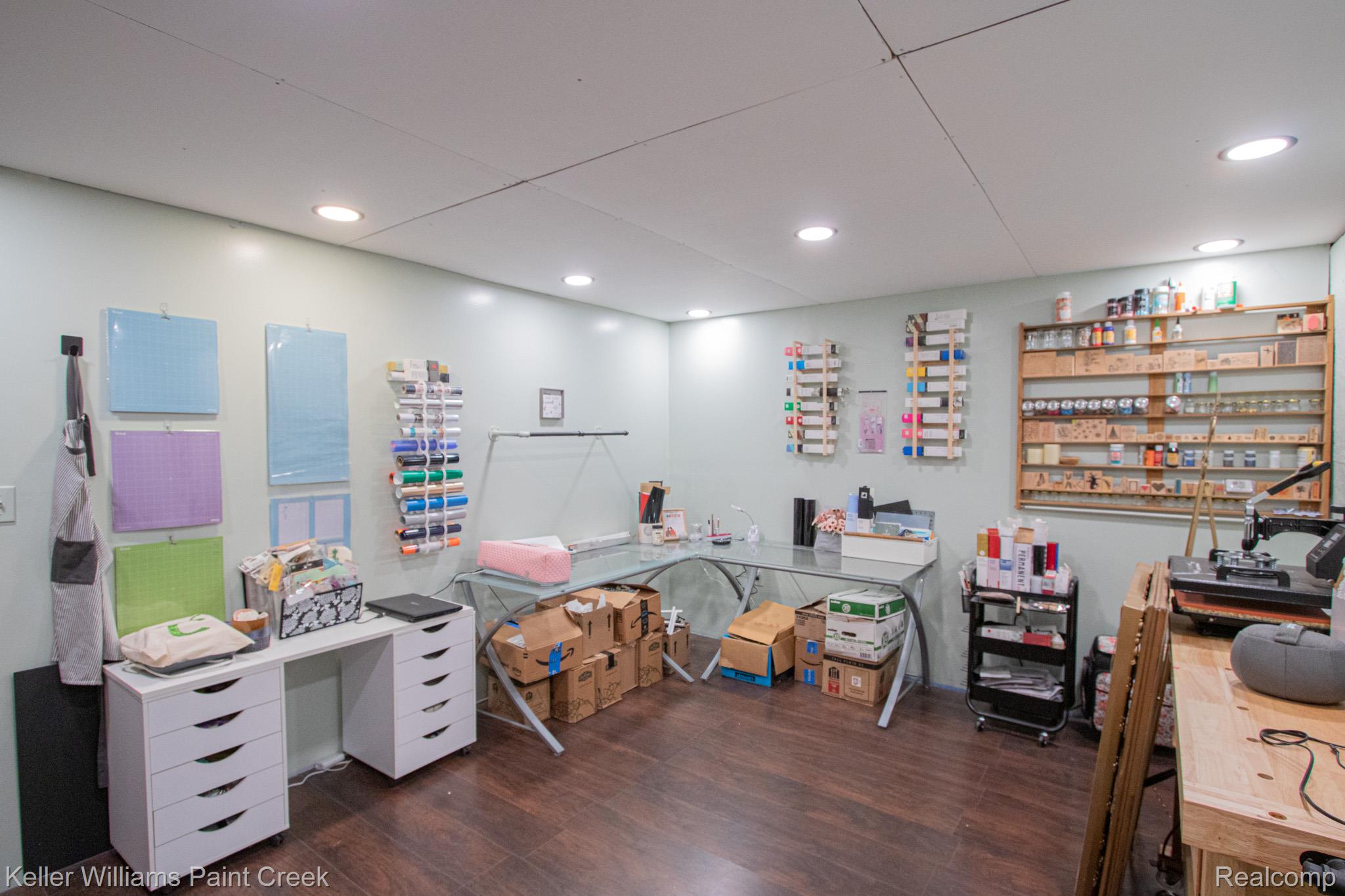625 Howell Road Allenton, MI 48002 - Photo 32 of 46 Recessed ceiling lighting illuminates the extensive built-in shelving, wood-finish flooring, and white cabinetry with drawer storage