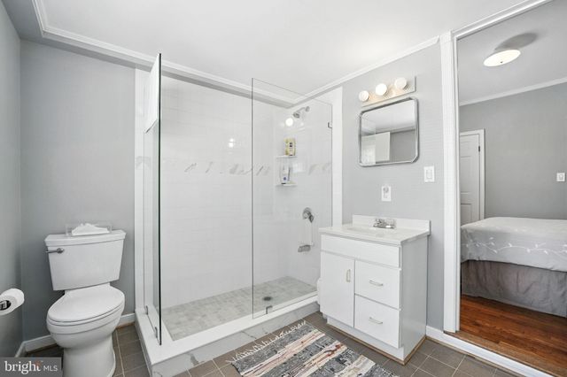 a bathroom with a shower a toilet and a sink