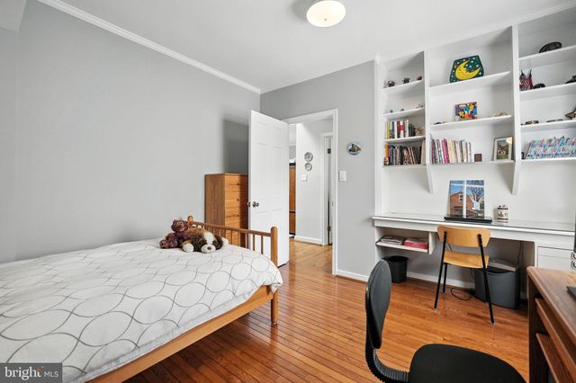 a bedroom with furniture and a wooden floor