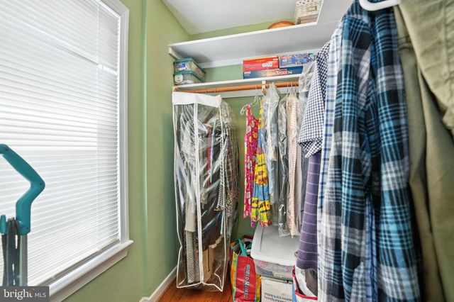 a view of walk in closet with clothes
