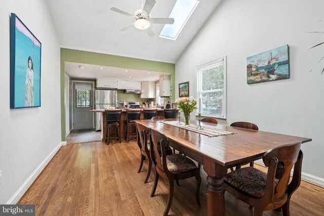 a dining room with a wooden table and chairs