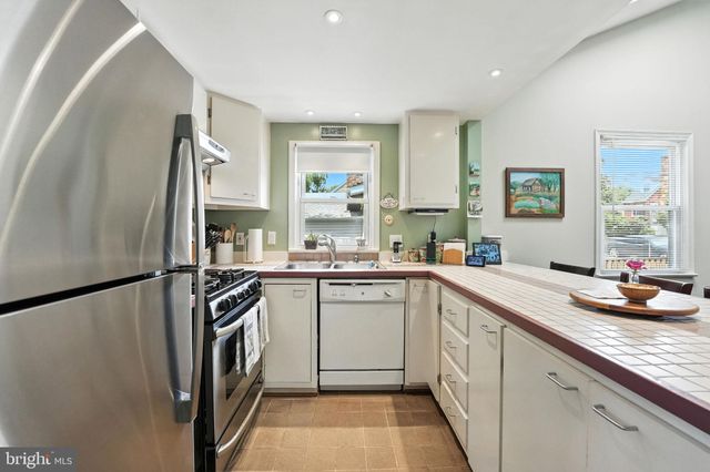 a kitchen with a sink a refrigerator and window