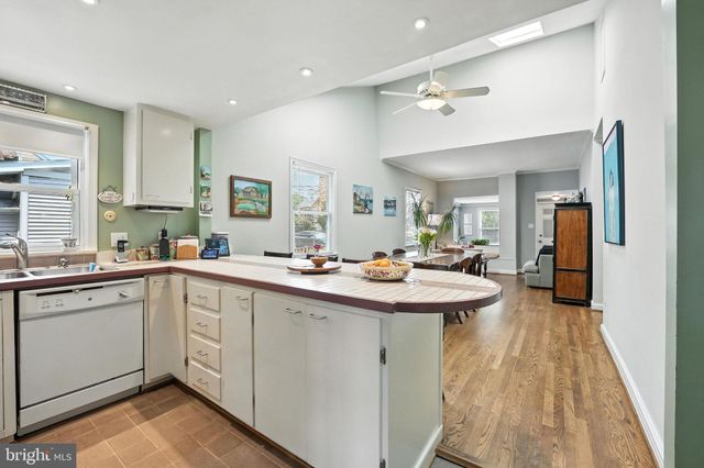 a kitchen with sink stove and refrigerator