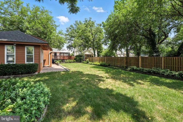 a view of a house with a yard and furniture