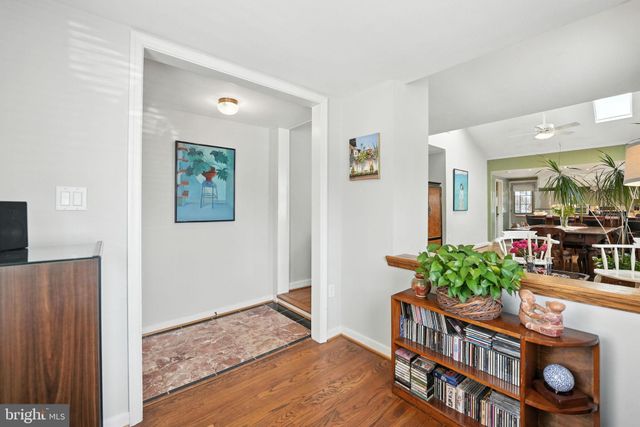 a living room with furniture and a bookshelf