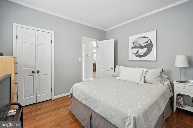 a bed room with a bed and a night stand