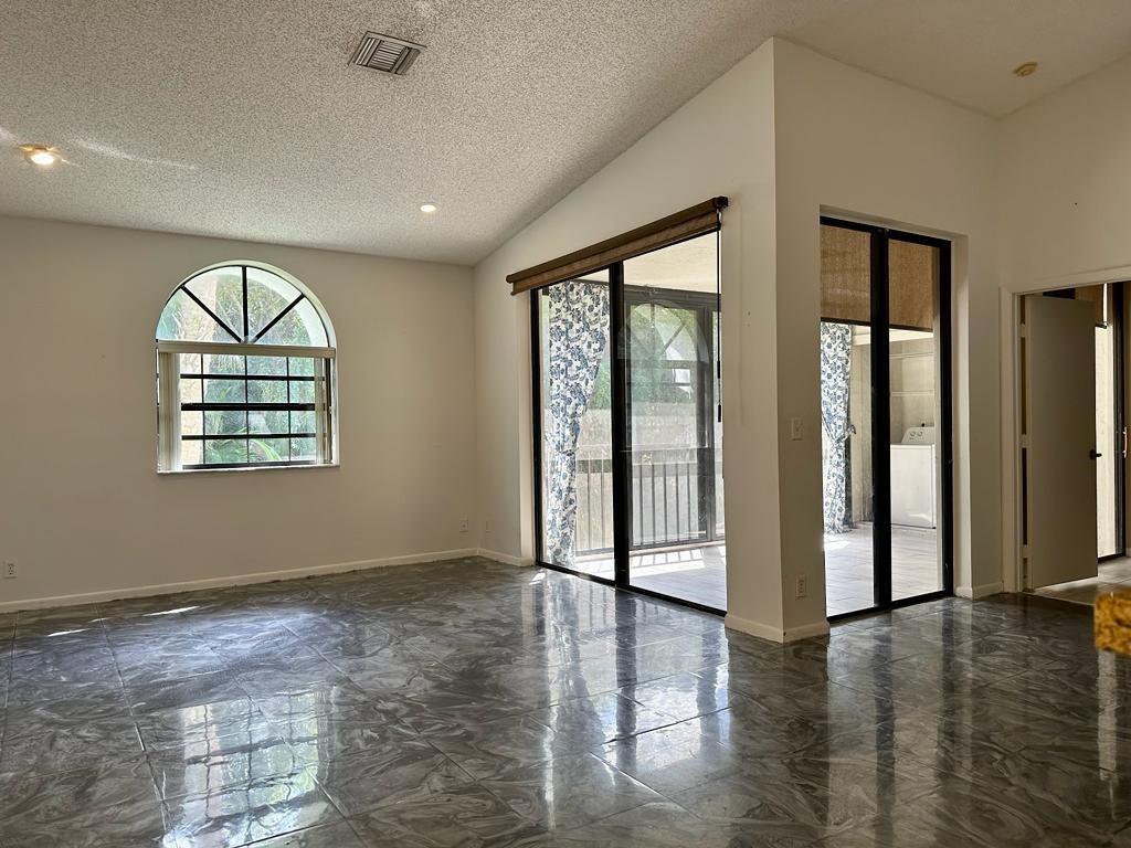 5438 Verona Drive, Unit 812 Boynton Beach, FL 33437 - Photo 1 of 35 an empty room with wooden floor and windows