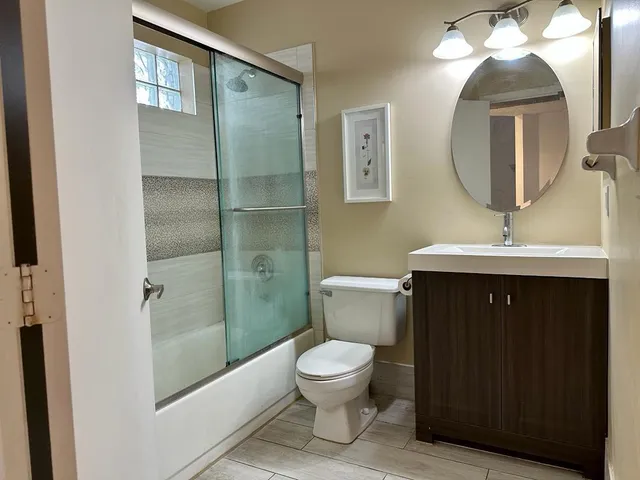 a bathroom with a toilet sink and mirror
