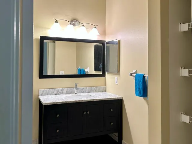 a bathroom with a double vanity sink and a mirror