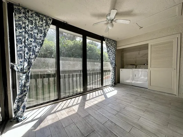 a view of a room with wooden floor and balcony