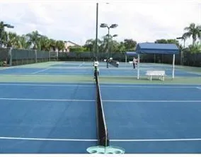 a room with pool table and chairs