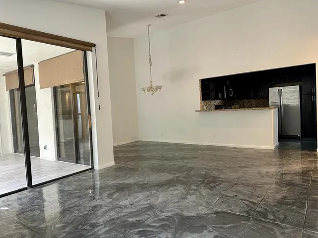 a view of a livingroom with wooden floor and a flat screen tv
