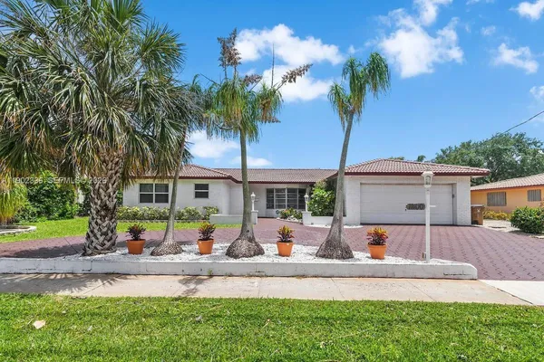 a view of a house with a yard and a patio