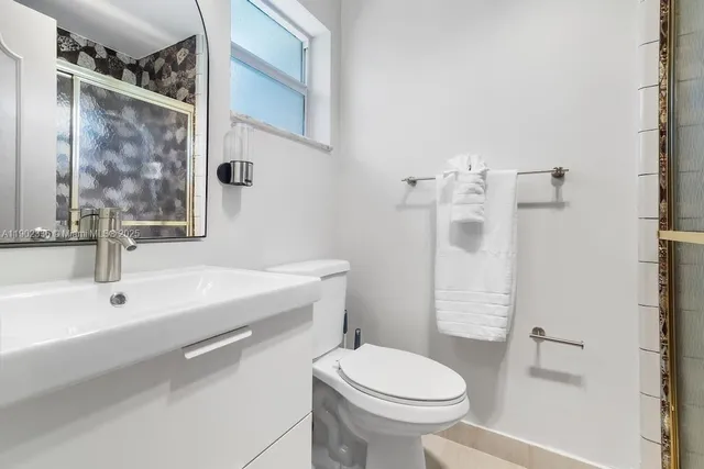 a bathroom with a sink toilet and shower